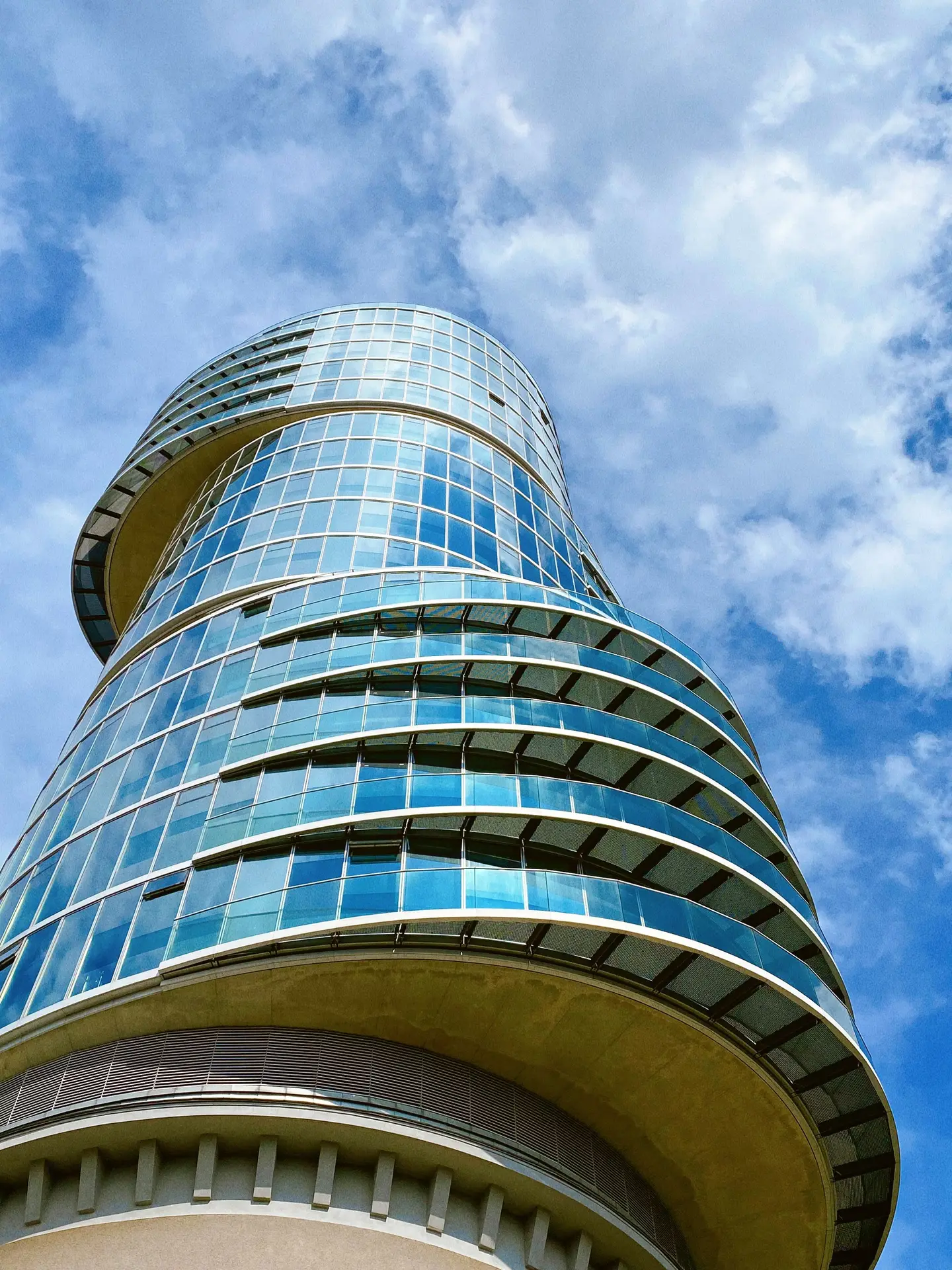 Curved glass and steel tower seen from below