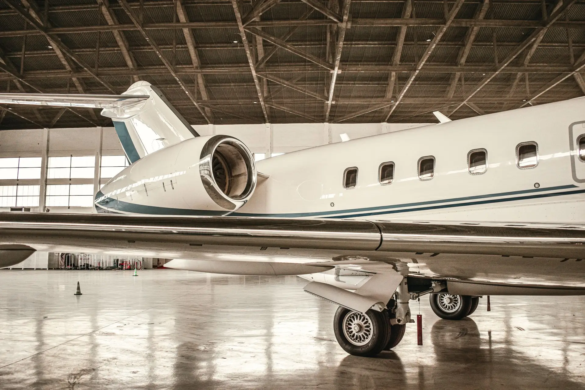 Business jet inside a modern aerospace hangar