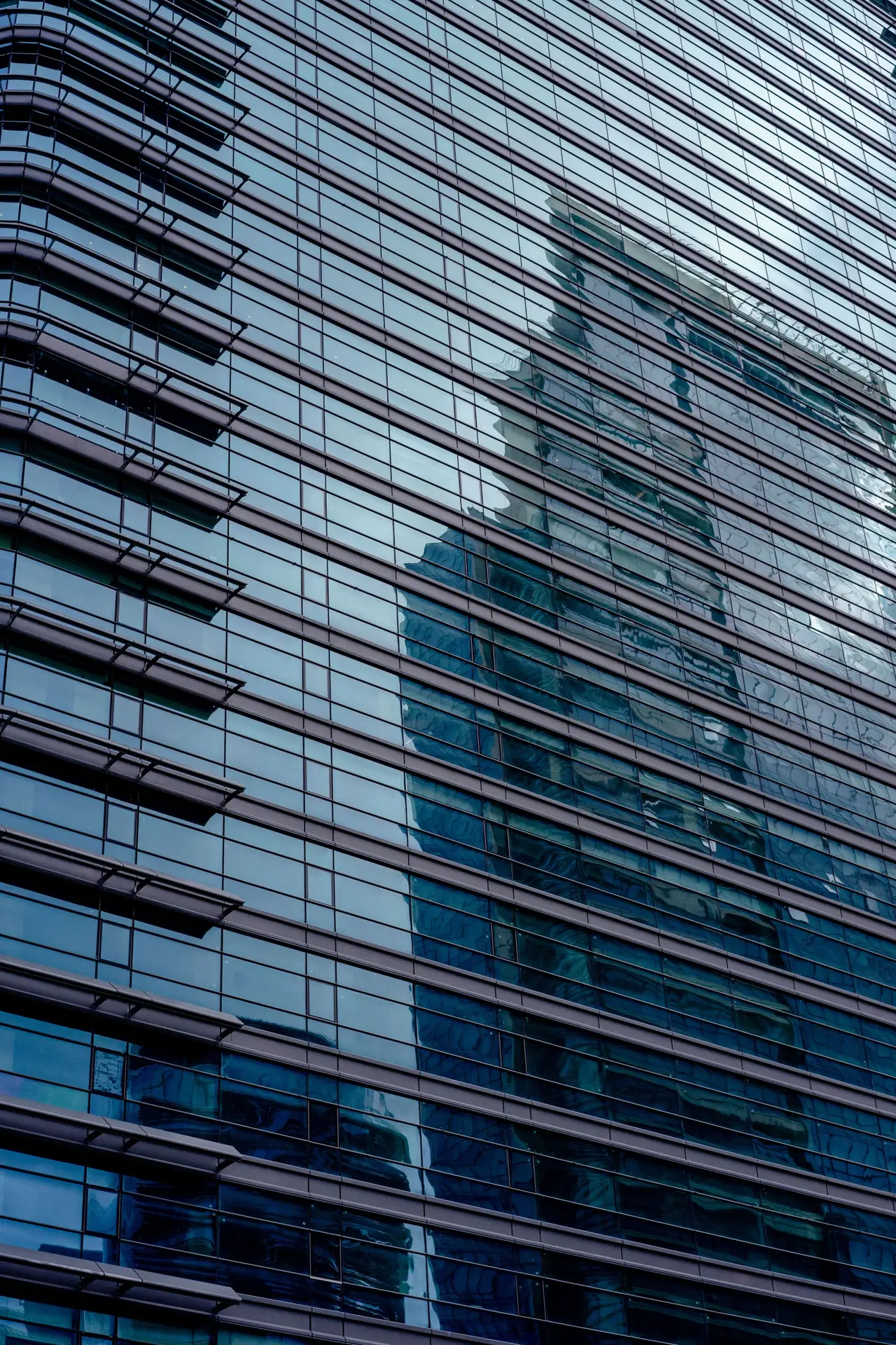Contemporary glass tower rising against the sky